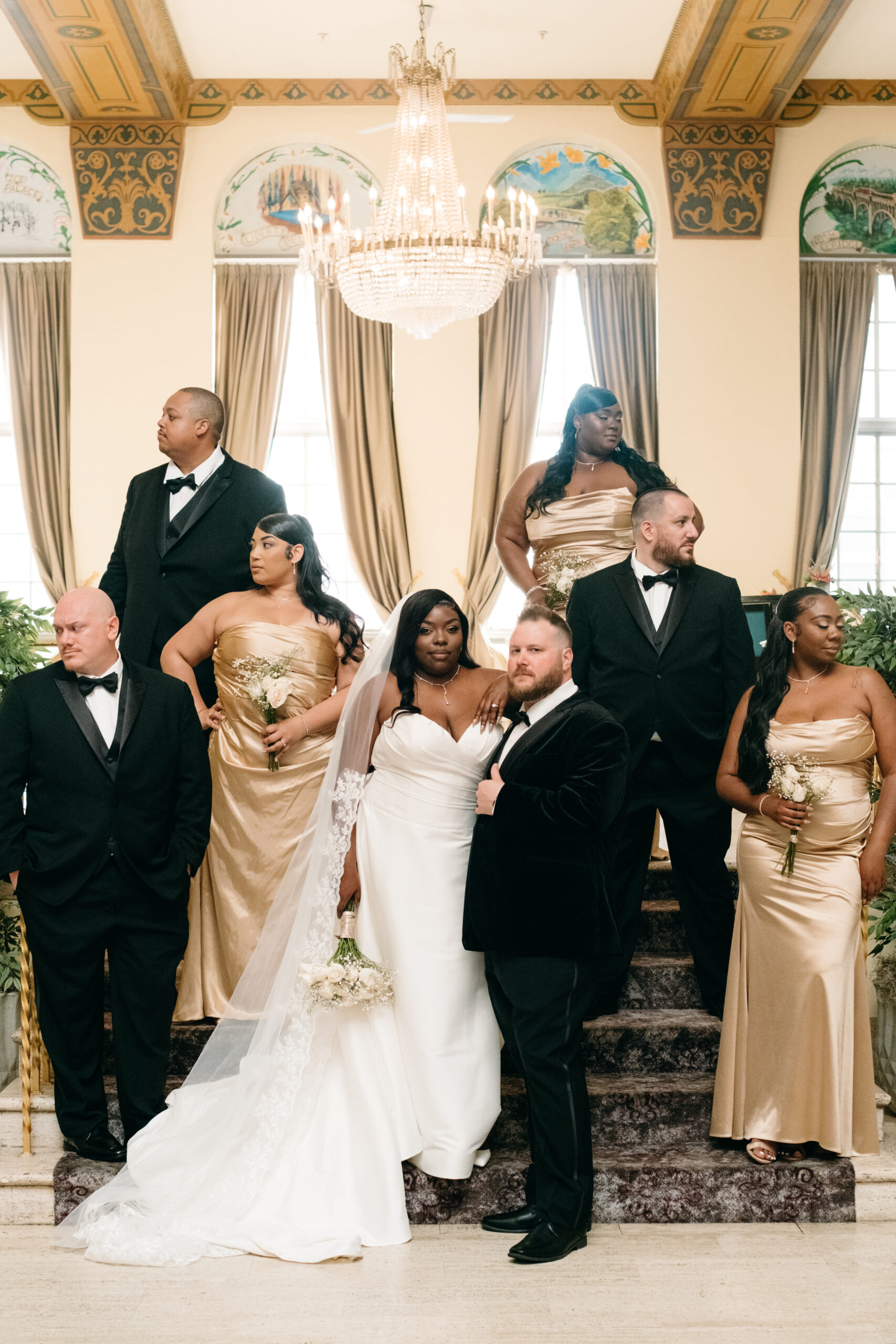 wedding party standing on stairs in elegant lobby of americus hotel allentown